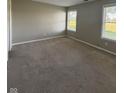Neutral bedroom with carpet, two windows and base trim around the bottom of the room at 8092 Crystal Ct, Avon, IN 46123