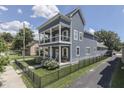 Side view of a two-story home with porches, fenced yard and a private driveway at 847 E Jefferson St, Franklin, IN 46131
