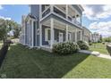 Angle view of a two-story home with a charming porch and beautifully landscaped yard at 847 E Jefferson St, Franklin, IN 46131