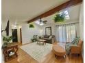 Bright living room with hardwood floors, skylight, and a cozy seating arrangement at 8829 Tracy Dr, Clayton, IN 46118