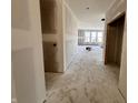 Under construction hallway showing an open layout, visible drywall, and natural light streaming in from the windows at 9417 Crimson Cir, Lapel, IN 46051