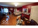 Cozy bedroom featuring hardwood floors, a decorative mirror, and ample natural light at 10720 Lakeview Dr, Carmel, IN 46033