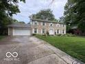 Traditional two-story home with stone exterior, attached garage, and green lawn at 10720 Lakeview Dr, Carmel, IN 46033