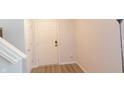 Bright entryway with light wood floors, white walls, and a white front door at 11445 Congaree Way, Indianapolis, IN 46235