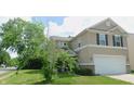 A charming two-story home with well-maintained landscaping and neutral-toned siding at 11445 Congaree Way, Indianapolis, IN 46235
