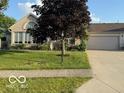Inviting home exterior featuring a well-maintained lawn and spacious two-car garage at 11503 Winding Wood Dr, Indianapolis, IN 46235