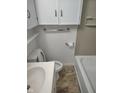 Clean bathroom features white cabinets above the toilet and a coordinated vanity at 5332 Fletcher Ave, Indianapolis, IN 46219