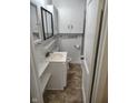 Cozy bathroom featuring a vanity with open shelves and a mirrored medicine cabinet at 5332 Fletcher Ave, Indianapolis, IN 46219