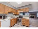 Traditional kitchen featuring oak cabinets, stainless steel appliances, and a view to the living room at 5370 Bay Harbor Dr, Indianapolis, IN 46254