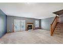 Spacious living room with a fireplace, plush carpet and sliding glass doors to the outside at 5370 Bay Harbor Dr, Indianapolis, IN 46254