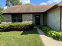 Home exterior with stone accents, green landscaping, and a covered front entryway at 7313 Shanna Cir, Indianapolis, IN 46236