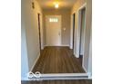 Inviting foyer with hardwood floors, a front door with decorative windows, and neutral paint at 7313 Shanna Cir, Indianapolis, IN 46236