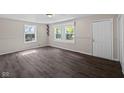Inviting living room with new wood-look flooring, fresh paint, and natural light at 7424 North Dr, Lawrence, IN 46226