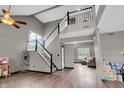 Bright, open living area with a staircase, high ceilings, and modern flooring at 793 Penny Ln, Pittsboro, IN 46167