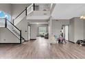 Spacious living room featuring high ceilings, wood floors, and a staircase leading to the second floor at 793 Penny Ln, Pittsboro, IN 46167