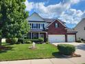 Charming two-story home featuring a well-maintained lawn, lush landscaping, and a welcoming curb appeal at 8433 Vyners Ln, Avon, IN 46123