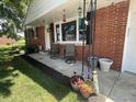 Inviting front porch with decorative plants and seating, showcasing the entrance to the home at 9783 Lee Ct, Columbus, IN 47203