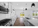 Modern kitchen featuring stainless steel appliances, granite countertops, and a functional island overlooking the backyard at 3980 Canning St, Danville, IN 46122