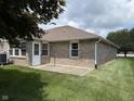 Backyard view features brick exterior and concrete patio at 951 Plaza W Dr # 7B, Martinsville, IN 46151