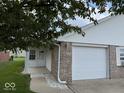 Exterior view of attached garage with walkway to covered entry at 951 Plaza W Dr # 7B, Martinsville, IN 46151