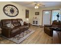Living room featuring laminate floors, leather furniture, and front door at 951 Plaza W Dr # 7B, Martinsville, IN 46151