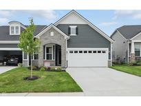 Charming home featuring stone accents, neutral siding, manicured lawn, and an attached two car garage at 16969 Cole Evans Dr, Noblesville, IN 46060