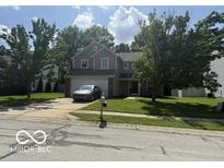 Charming two-story home with mature trees, well-manicured lawn, and attached two-car garage at 17902 Cristin Way, Westfield, IN 46062