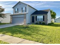 Charming two-story home with a well-manicured lawn and a two car garage at 1327 Blue Ridge Ln, Brownsburg, IN 46112