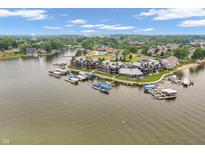 Stunning aerial view of lakeside condos with docks, lush green landscaping, and community amenities at 102 Clarendon Dr # 409, Noblesville, IN 46062