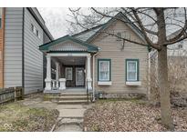 Charming home featuring a covered porch, well-maintained siding, and a welcoming facade at 1433 E Fletcher Ave, Indianapolis, IN 46203