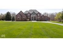 Beautiful brick home with manicured lawn and well maintained landscaping at 4499 W 131St St, Carmel, IN 46074