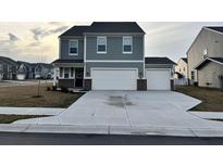 Charming two-story home with a two car garage and manicured landscaping at 696 Scarsdale Ln, Danville, IN 46122