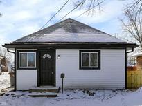 Charming home with a black and white exterior, complete with a snowy rooftop at 5845 Rawles Ave, Indianapolis, IN 46219