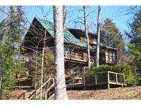 Charming multi-level home nestled in a wooded setting, with a welcoming deck and natural landscaping at 6486 Coyote Dr, Nineveh, IN 46164