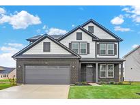 Charming two-story home with a brick facade, gray trim, well-manicured lawn, and attached two-car garage at 5731 Palazzo Ln, McCordsville, IN 46055