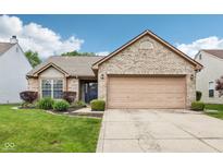 Charming brick home features a two-car garage, manicured lawn, and a welcoming entrance at 778 Kingston Cir, Brownsburg, IN 46112