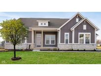 Gray farmhouse exterior with white trim, stone accents, and a two-car garage at 11362 Selsey Rd, Fishers, IN 46040