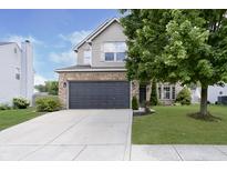 Two-story house with a gray garage door and landscaped lawn at 10561 Sand Creek Blvd, Fishers, IN 46037