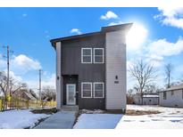 Modern two-story home with gray and white siding, snowy front yard at 1005 W 25Th St, Indianapolis, IN 46208