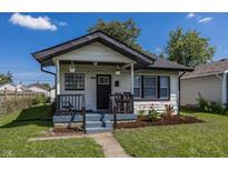 Charming bungalow with a renovated front porch and landscaped yard at 3848 Spann Ave, Indianapolis, IN 46203
