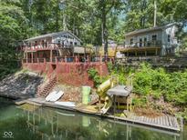 Lakefront home featuring a slide into the water, perfect for outdoor entertaining and enjoying water activities at 6141 Flamingo Dr, Nineveh, IN 46164