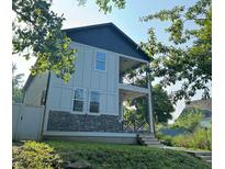 Two-story modern home with gray siding, stone accents, and a front porch at 401 Jefferson Ave, Indianapolis, IN 46201