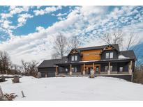 Stunning two-story home with a modern farmhouse design, featuring a covered porch and snow-covered yard at 2101 N Wolf Cv, Martinsville, IN 46151