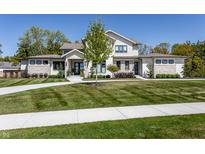 Inviting two-story home with stone accents, manicured lawn, and a circular driveway at 340 Beechwood Farm Ln, Indianapolis, IN 46260
