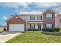 Charming two-story home with brick accents, a well-maintained lawn, and an attached two-car garage at 11851 Fawn Crest Dr, Indianapolis, IN 46235