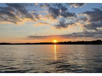 Beautiful sunset view over the water with colorful clouds and the sun reflecting on the water at 11320 Fonthill Dr, Indianapolis, IN 46236