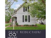 Charming two-story home with traditional architecture, black shutters, and a inviting front porch at 47 Meadow Dr, New Palestine, IN 46163