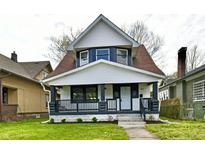 Charming two-story home with a front porch, white siding, and a well-manicured front lawn at 3634 N Kenwood Ave, Indianapolis, IN 46208