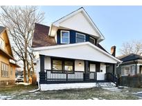 Two-story house with a white exterior, dark trim, and a welcoming front porch at 3634 N Kenwood Ave, Indianapolis, IN 46208