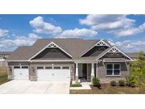 Brick house with 3-car garage, and landscaping at 7834 Fairwood Blvd, Plainfield, IN 46168